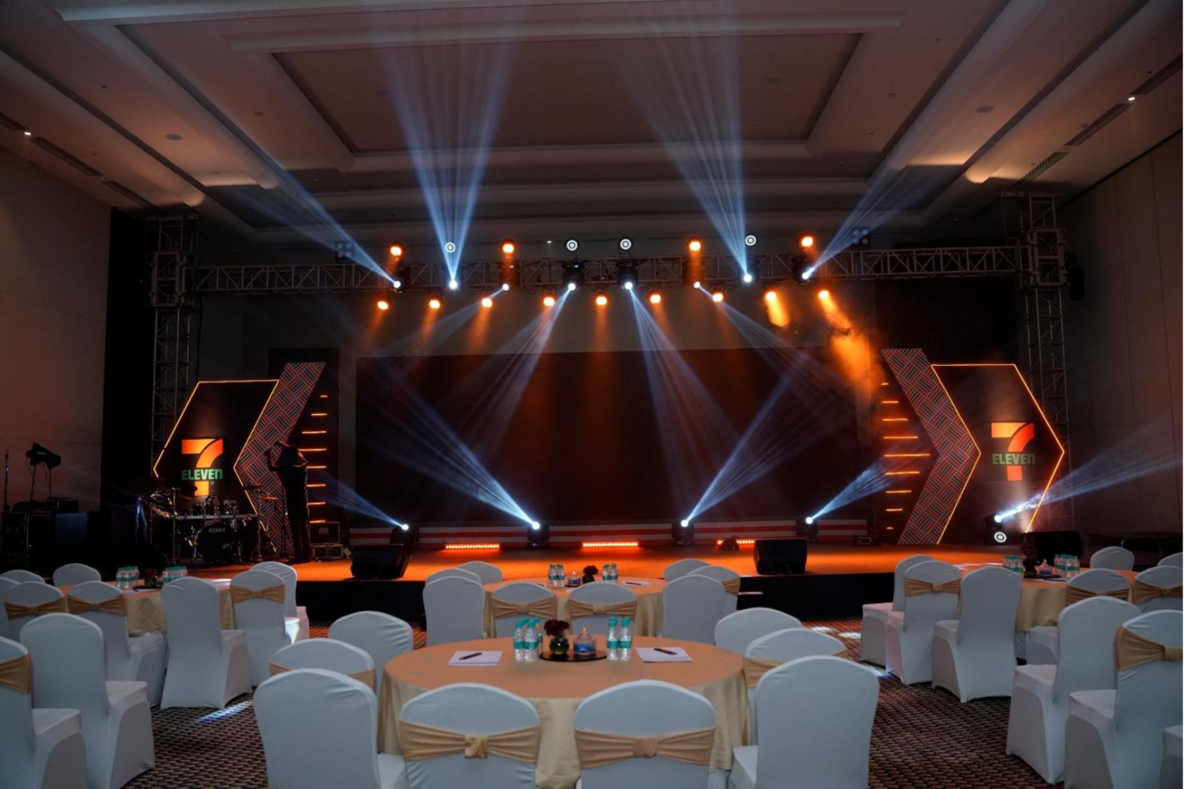 A stage with lights and tables

AI-generated content may be incorrect.